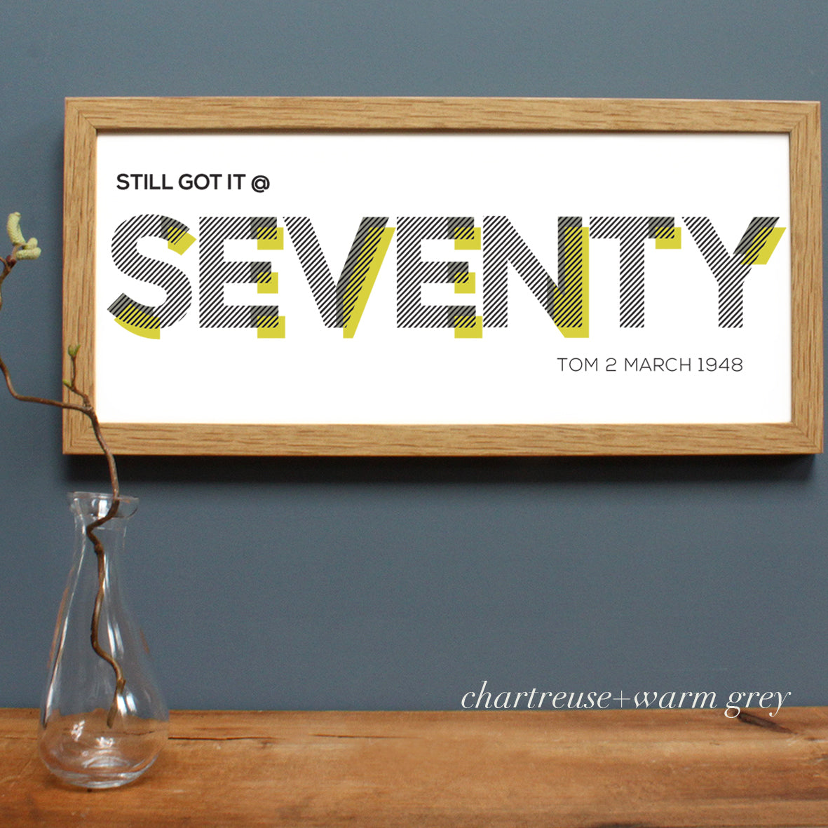 seventy black lettering print in an oak frame
