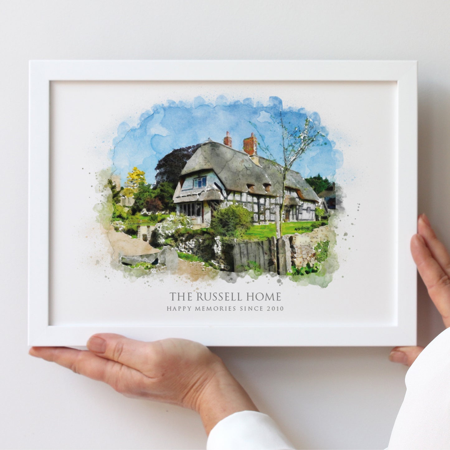 watercolour illustration of a traditional thatched cottage in a white A4 landscape frame