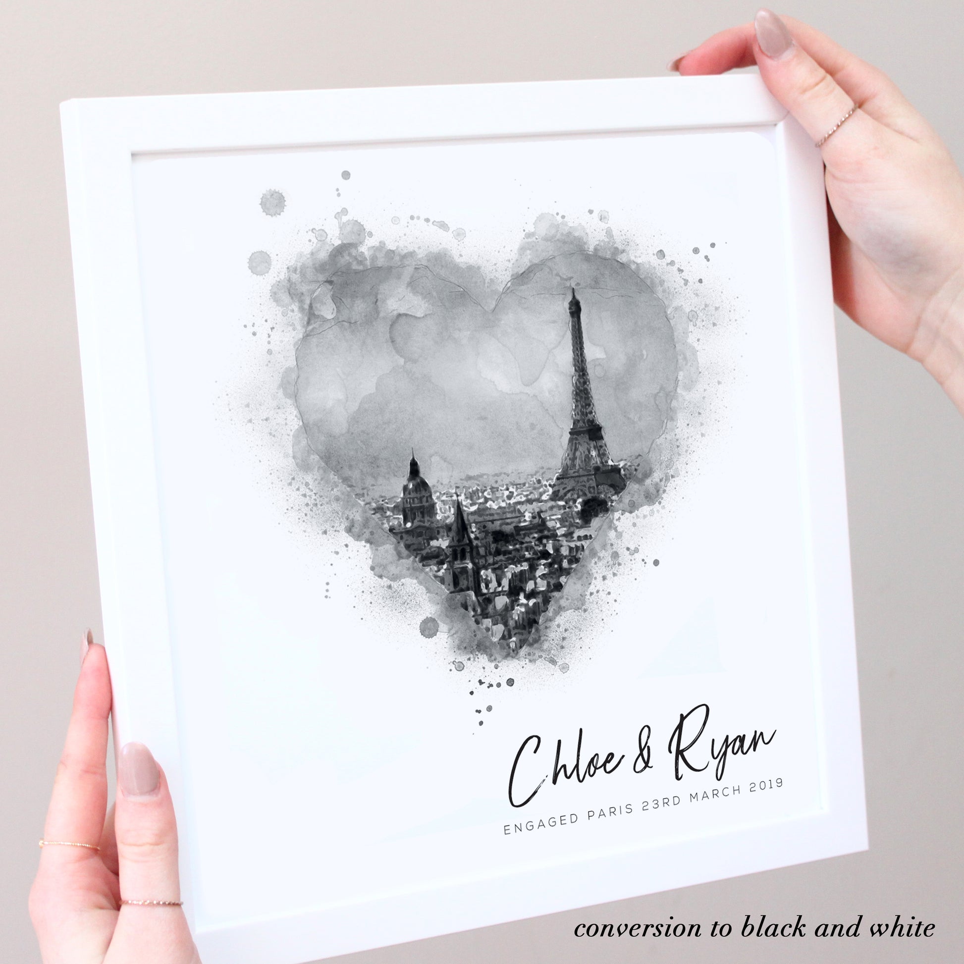 black and white illustration of Paris in white frame with hands