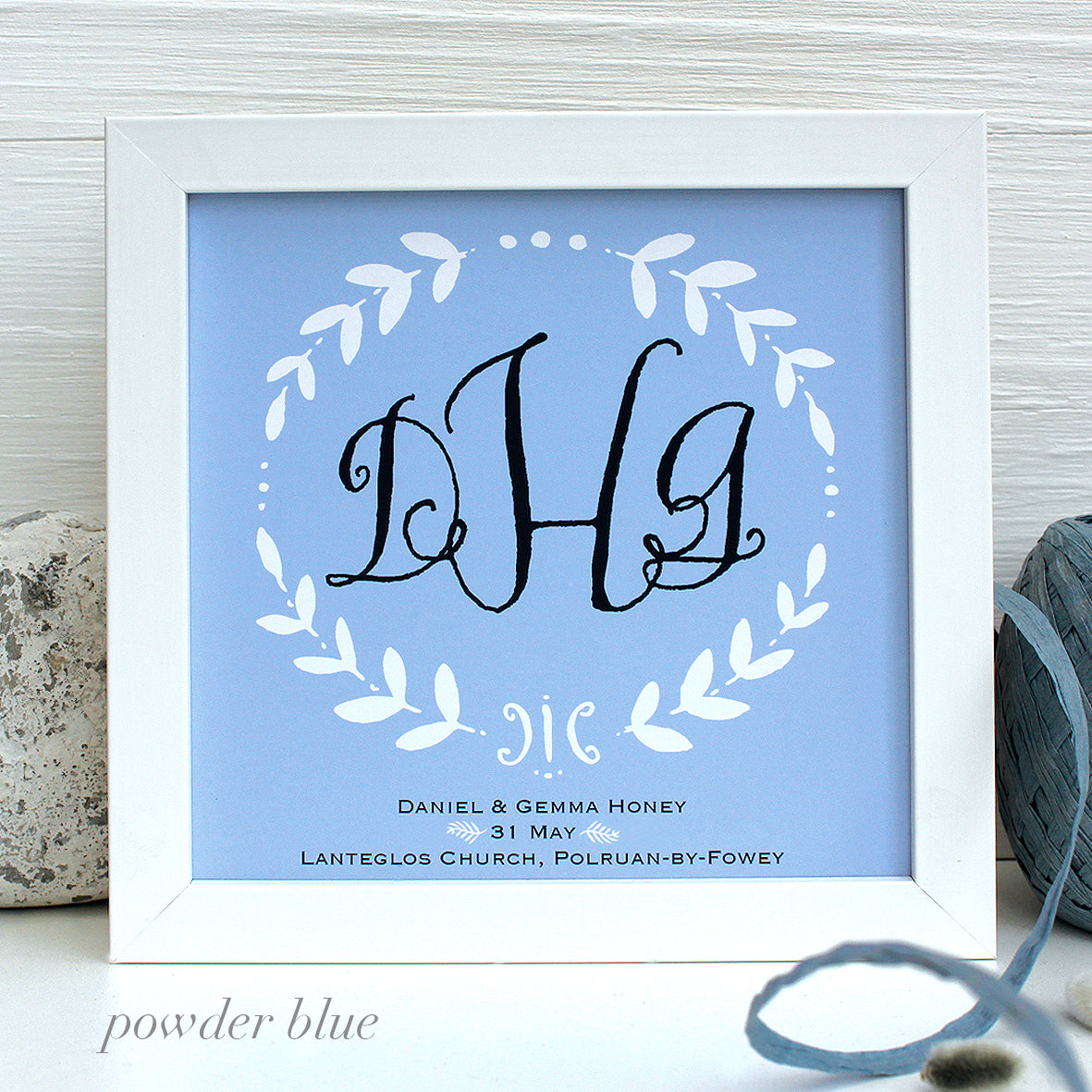 wedding gift monogram on a powder blue background with white wooden frame