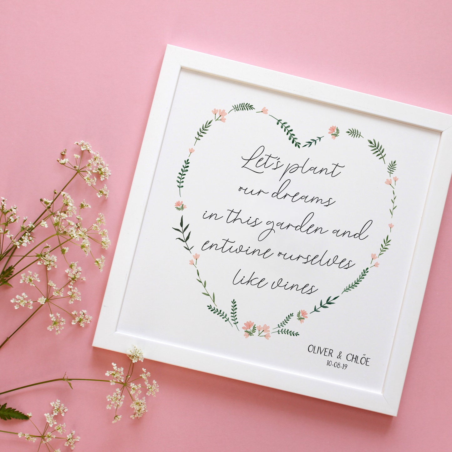 engagement floral heart with quote in a white frame on a pink background
